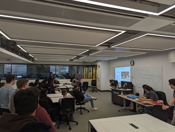 NUCATS members listening to a presenter at a BAE hackathon.