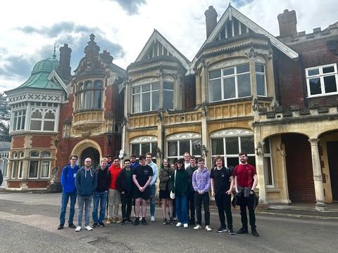 A photo of NUCATS trip attendees standing infront of Bletchley Park.